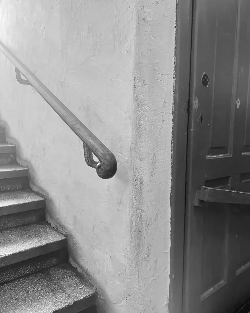 Original staircase and wooden handrail in a 1936 Kamionek tenement in Warsaw