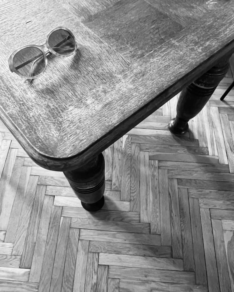 120-year-old wooden table with vintage glasses in a lived-in Kamionek apartment