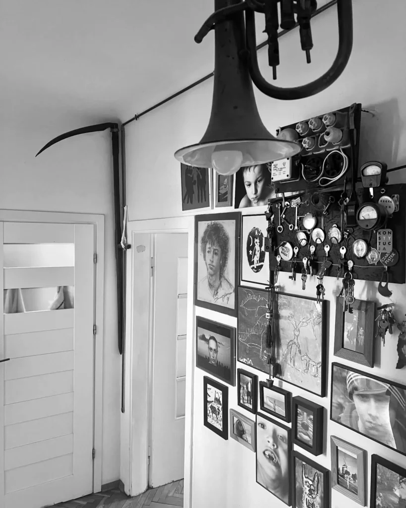 Original fuse box, fringed hallway lamp and family artwork in a lived-in Kamionek home